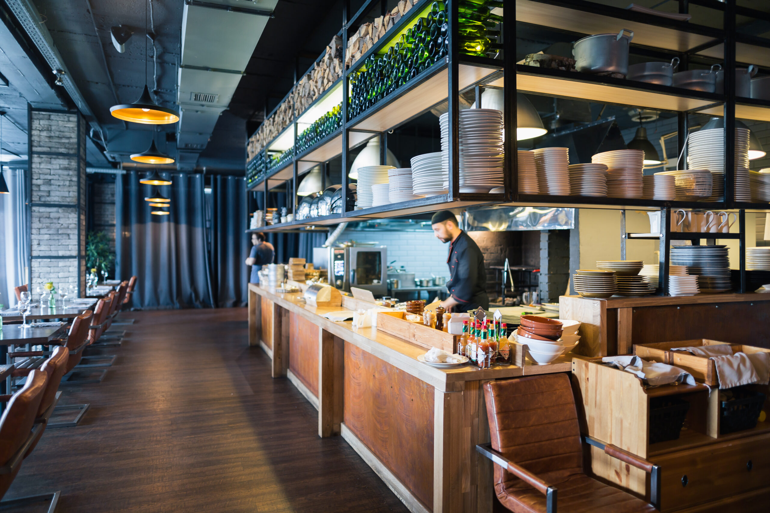 Chef cooking in an open restaurant kitchen.